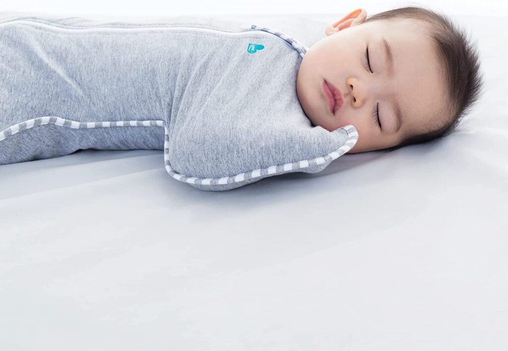 Baby sleeping comfortably in a swaddle blanket