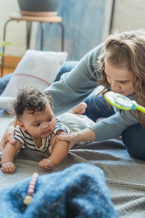 mom teaches baby how to crawl