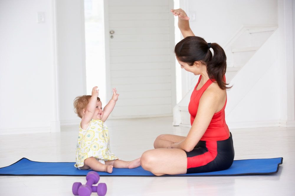 Mom teaching her baby yoga so that she can crawl 